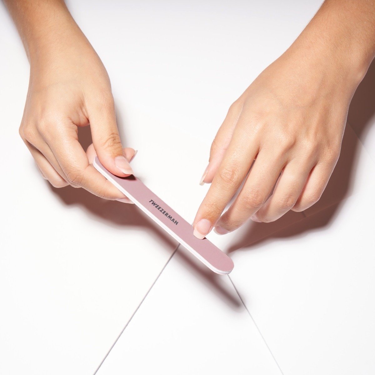 Model using pink nail file